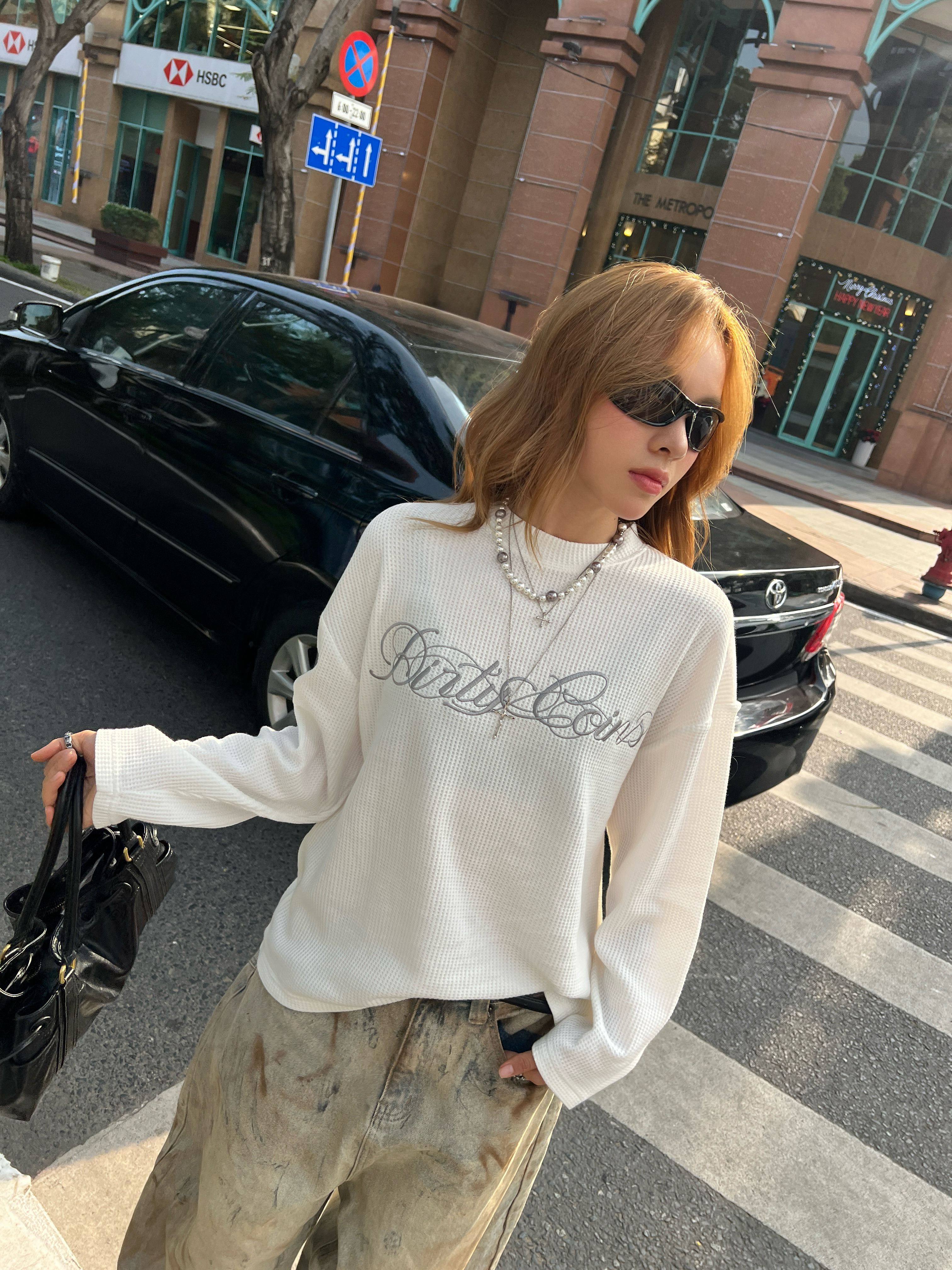 Woman in textured knit top and jeans